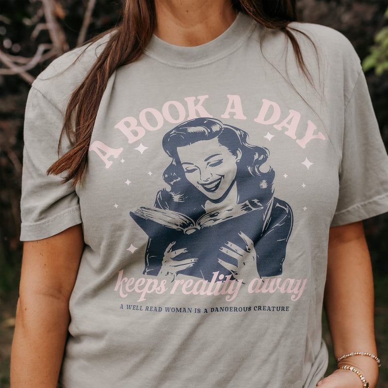 A Book A Day Keeps Reality Away - Comfort Colors Tee